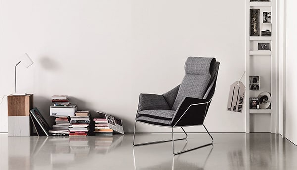 Large black leather armchair in a minimalist room.