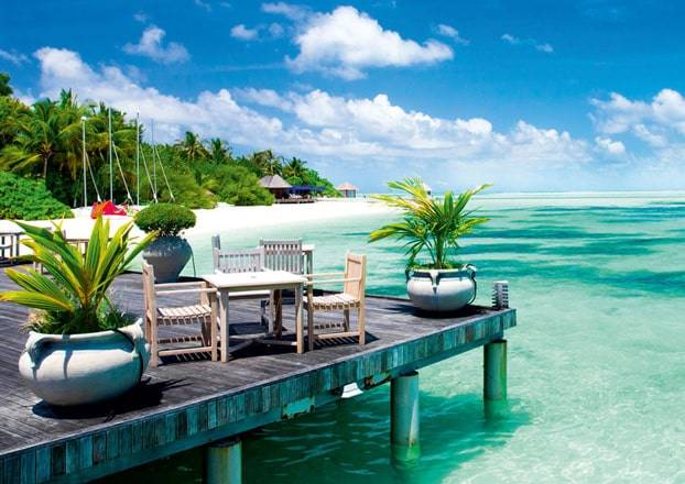 Private deck with seating over turquoise water
