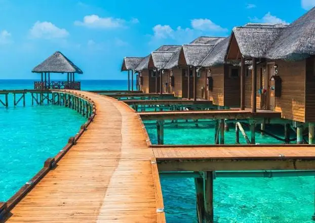 Wooden walkway leading to overwater villas